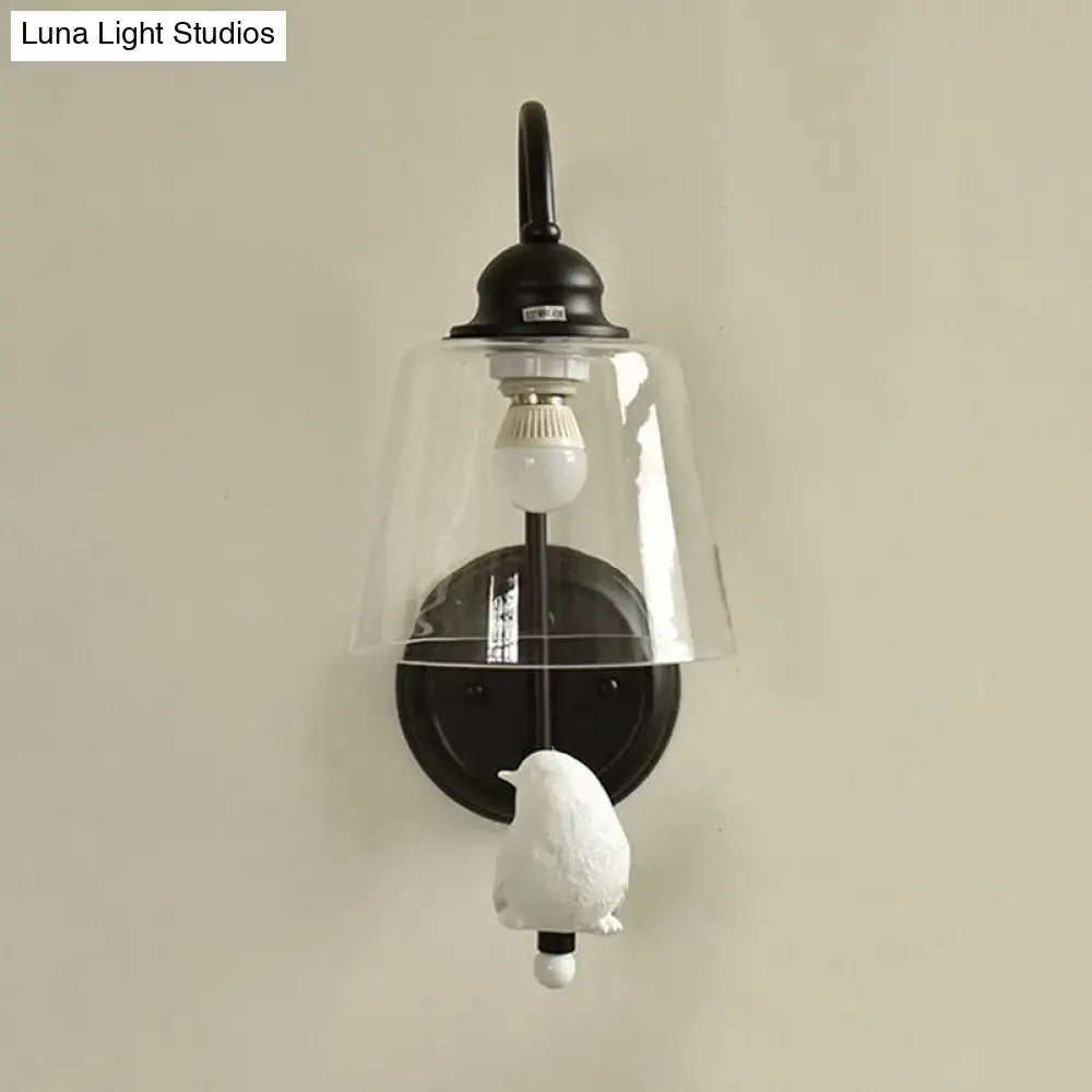 Modernist black metal cone wall lamp with clear glass bell shade and white ceramic bird figurine for bedroom use