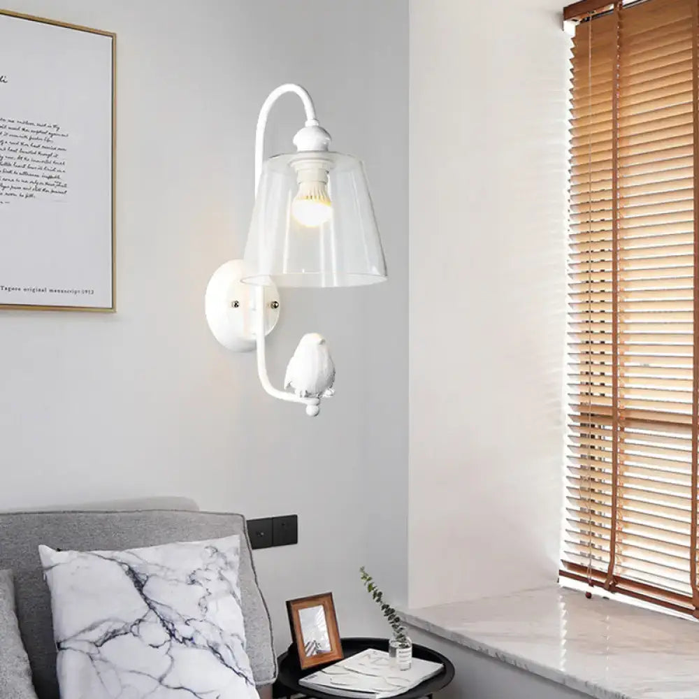 Modernist black and white cone wall lamp with white ceramic bird on curved metal arm and clear glass shade wall lamp