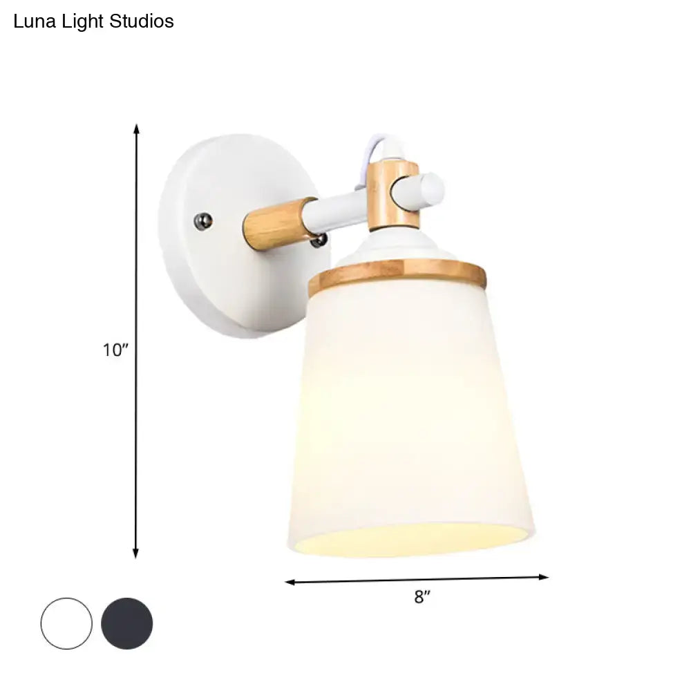 Modernist wall lamp with white black wood finish and cream glass shade for bedroom lighting