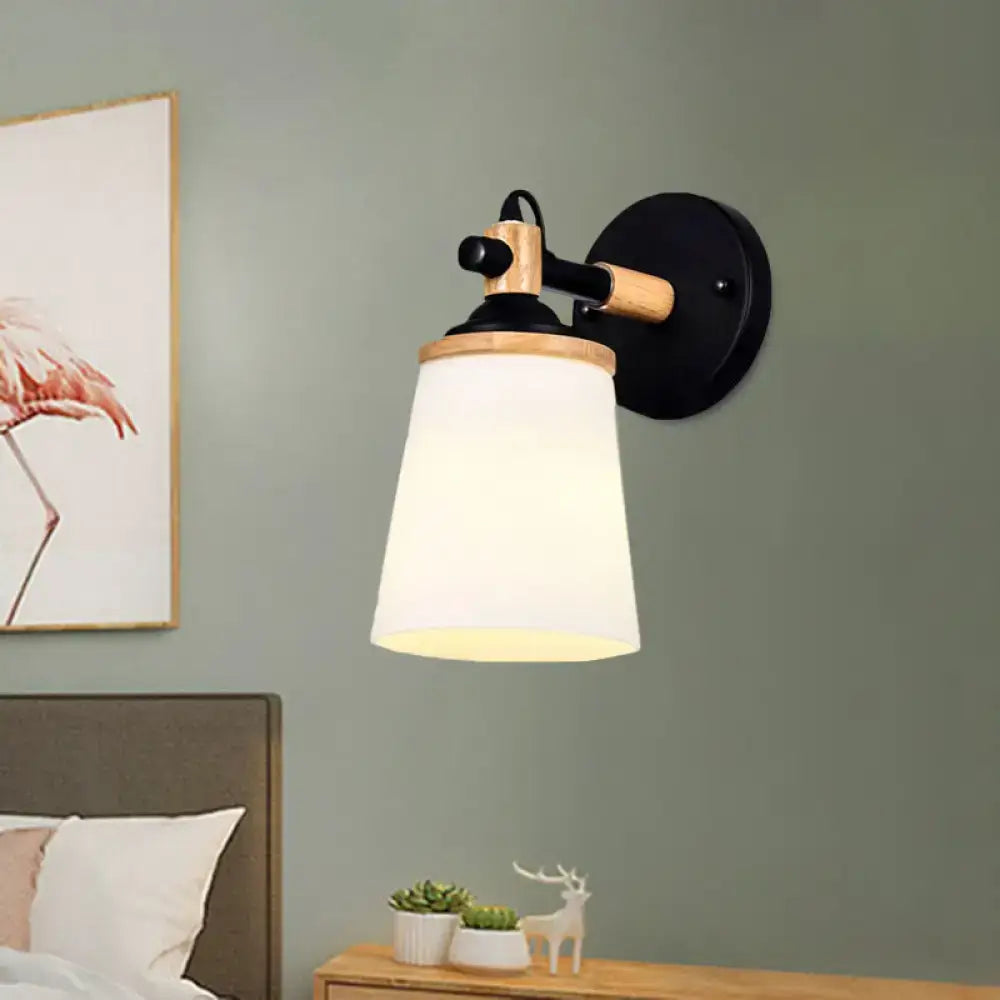 Modernist wall lamp with black and wood finish and cream glass shade ideal for bedroom lighting