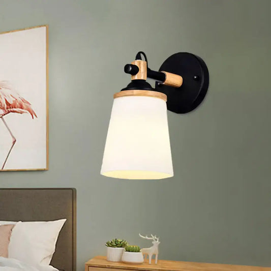 Modernist wall lamp with black and wood finish and cream glass shade ideal for bedroom lighting