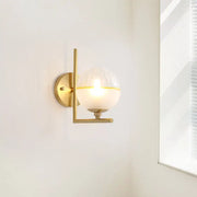 Modernist brass direct wired electric wall sconce with frosted glass globe and yellow accent band for bedroom light fixture