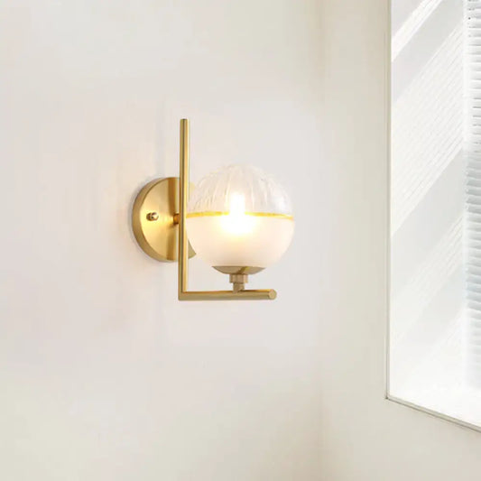 Modernist brass direct wired electric wall sconce with frosted glass globe and yellow accent band for bedroom light fixture