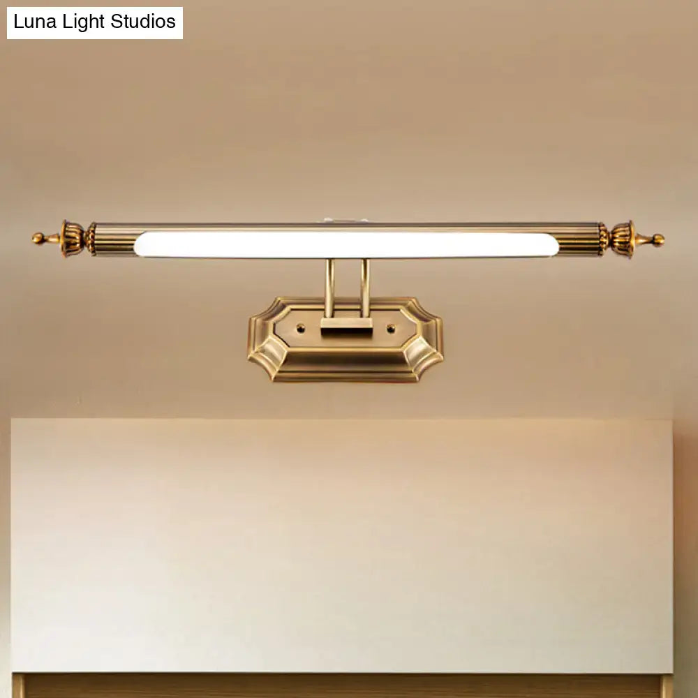 Modernist brass led vanity light fixture with gold finish, sleek rectangular design, ornate ends, and frosted glass sconce