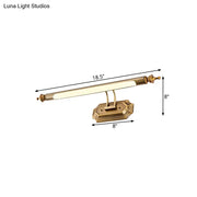 Brass-finished led vanity light fixture with frosted glass diffuser and ornate ends for modern bathroom use
