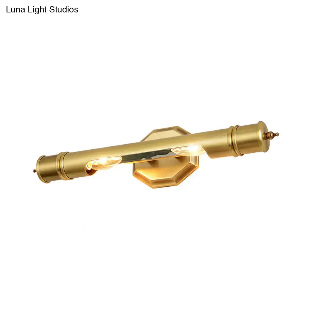 Brass-finished modernist wall sconce with cylindrical design and hexagonal backplate for 110-120v maximum bulb wattage