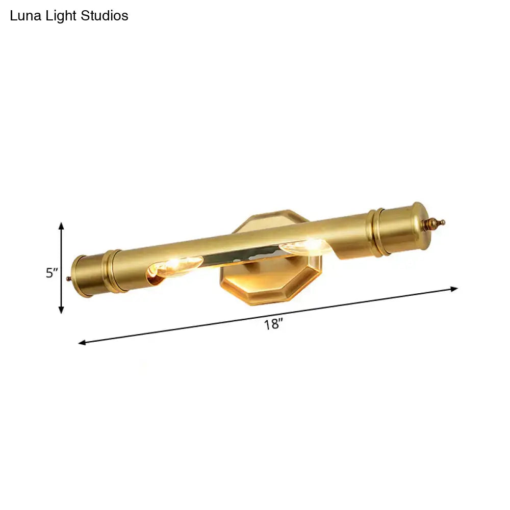 Brass-finished modernist wall sconce with cylindrical design and hexagonal backplate for 110-120v maximum bulb wattage