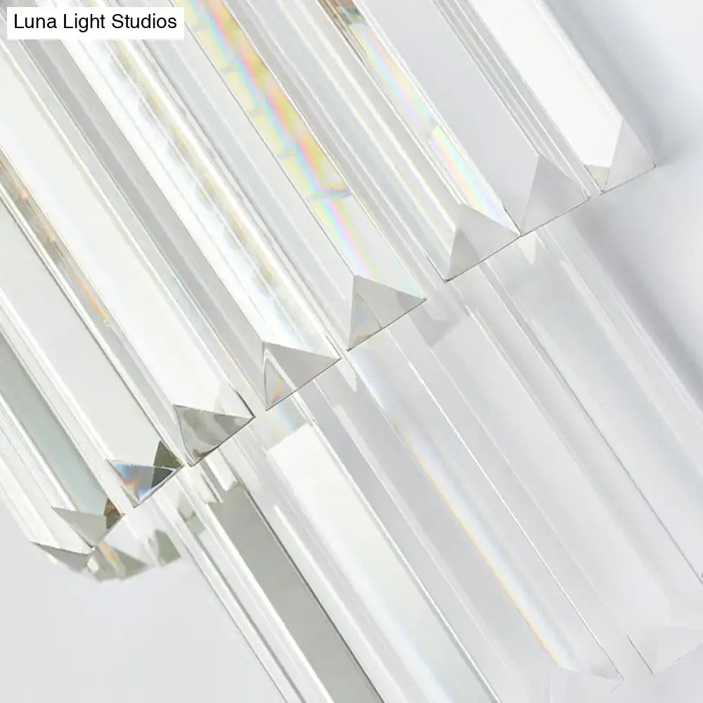 Modernist gold and clear crystal cylinder wall lighting fixture with faceted crystal arms and a geometric design