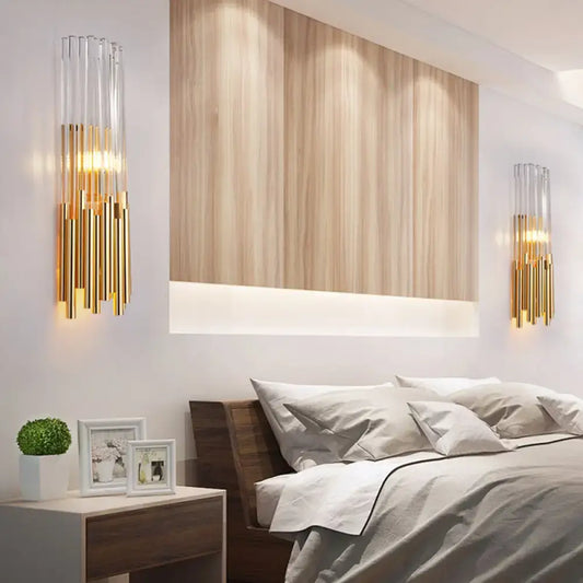 Modernist gold and clear glass cylinder wall light fixture with elegant design ideal for bedroom wall sconce use