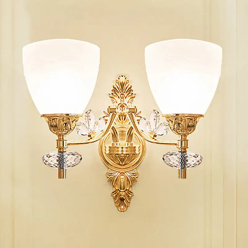 Modernist gold finish wall light with crystal accents and two frosted glass bulb base shades for bedroom sconce