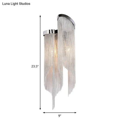Chrome-finished aluminum tassel wall sconce with cascading silver chain fringe for modernist living room lighting
