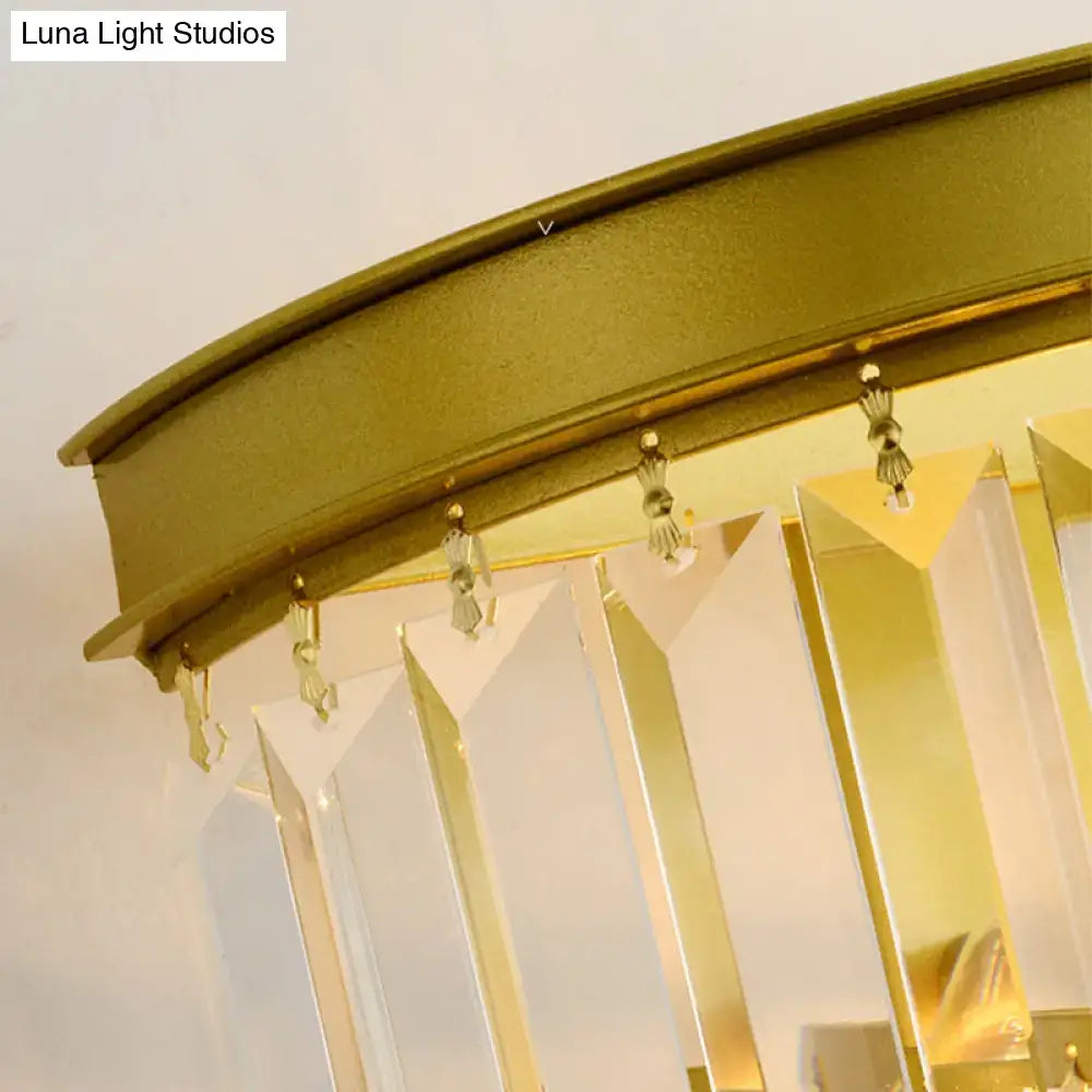 Modernist gold wall lamp featuring clear faceted crystal prisms hanging from a curved metallic frame for living room