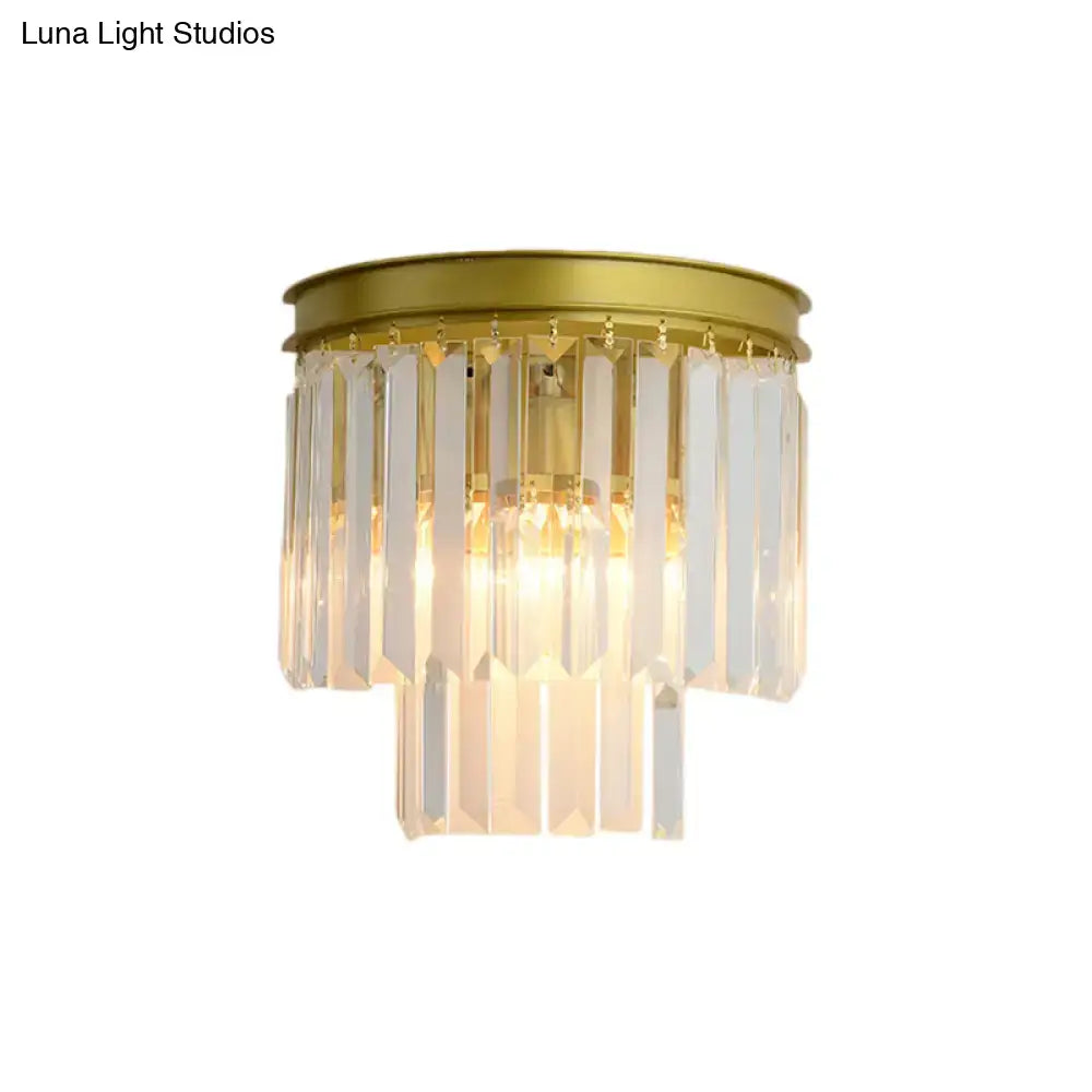 Modernist gold wall lamp featuring clear faceted crystal prisms designed for elegant living room lighting