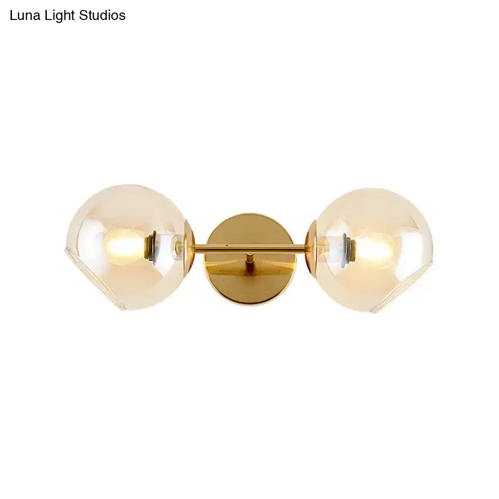 Modernist gold wall lamp with two smoked glass shade globes for living room featuring a stylish wall lamp design