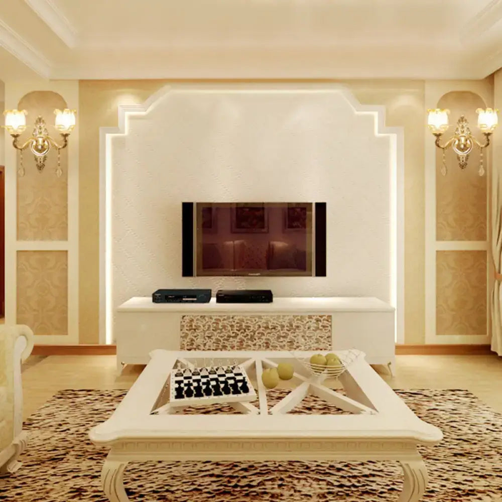White ornate coffee table with geometric design and lattice inlays paired with modernist gold wall sconce with glass shade direct wired electric
