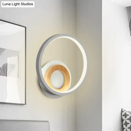 Modernist gray and wood ring wall sconce with sleek outer ring and warm wood accent ideal for bedroom led lighting