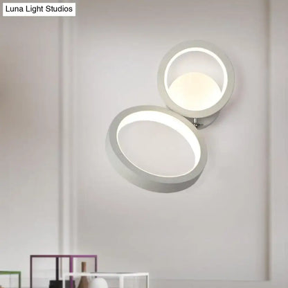 Modernist matte beige double ring wall lamp with a sleek white circular led sconce for bedroom corners