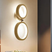 Modernist matte beige double ring wall lamp with warm minimalist design ideal for bedroom corners