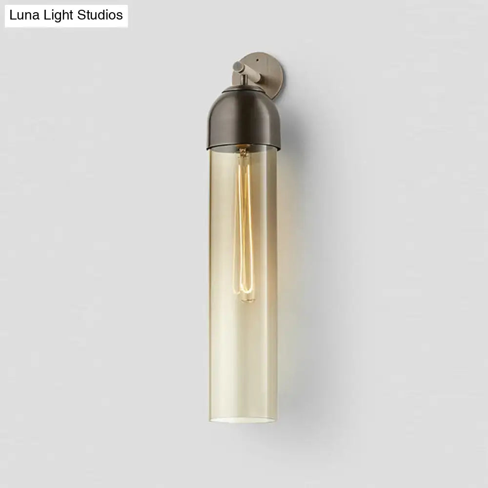 Modernist metallic tube sconce light with amber glass and brushed metal for bedroom featuring a curved arm