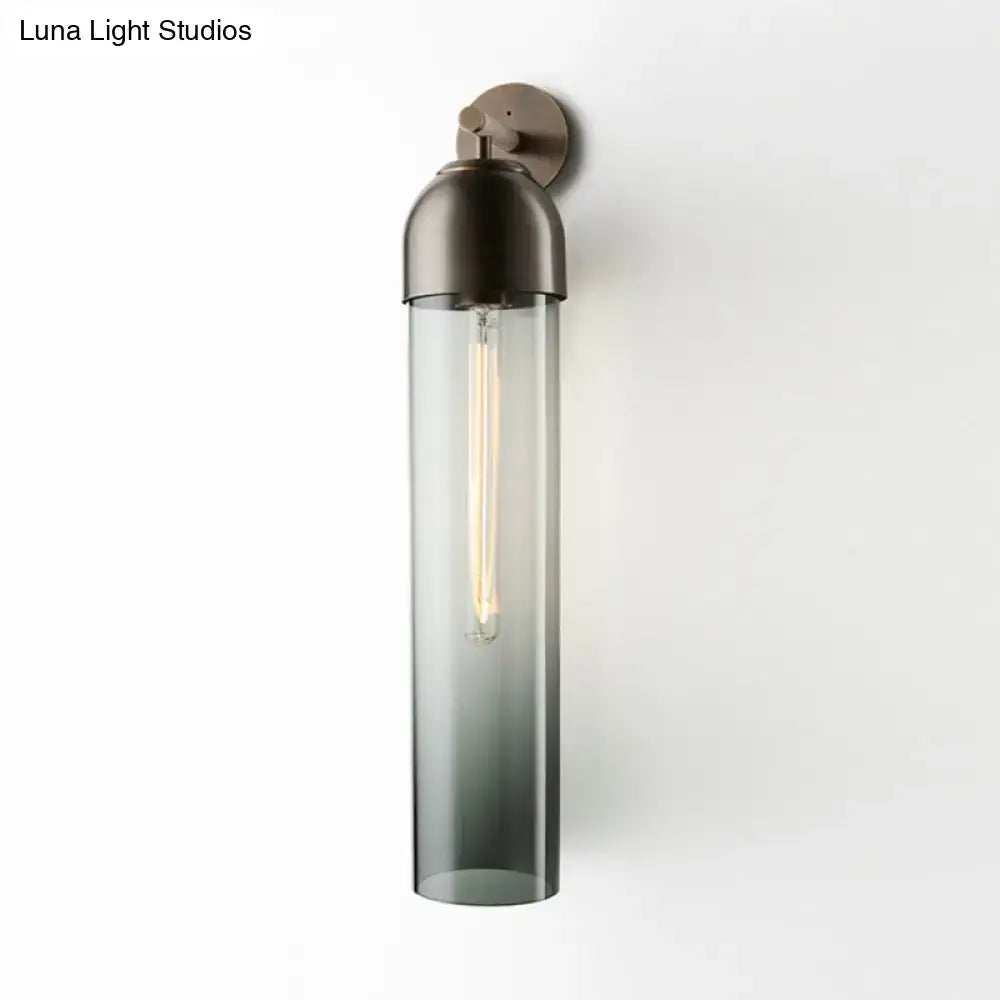 Modernist tube sconce light with dark bronze metal and amber glass cylinder for bedroom wall lighting