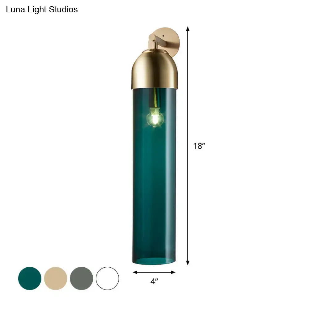 Teal glass tube sconce light with brass-finished top and mounting bracket for modernist bedroom use