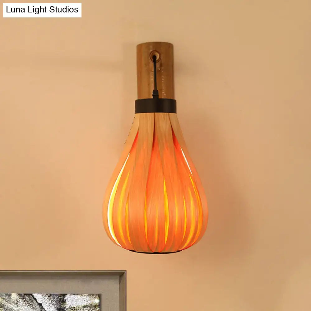 Modernist orange wood slat foyer wall sconce featuring a warm ribbed pendant light with bamboo wall mount