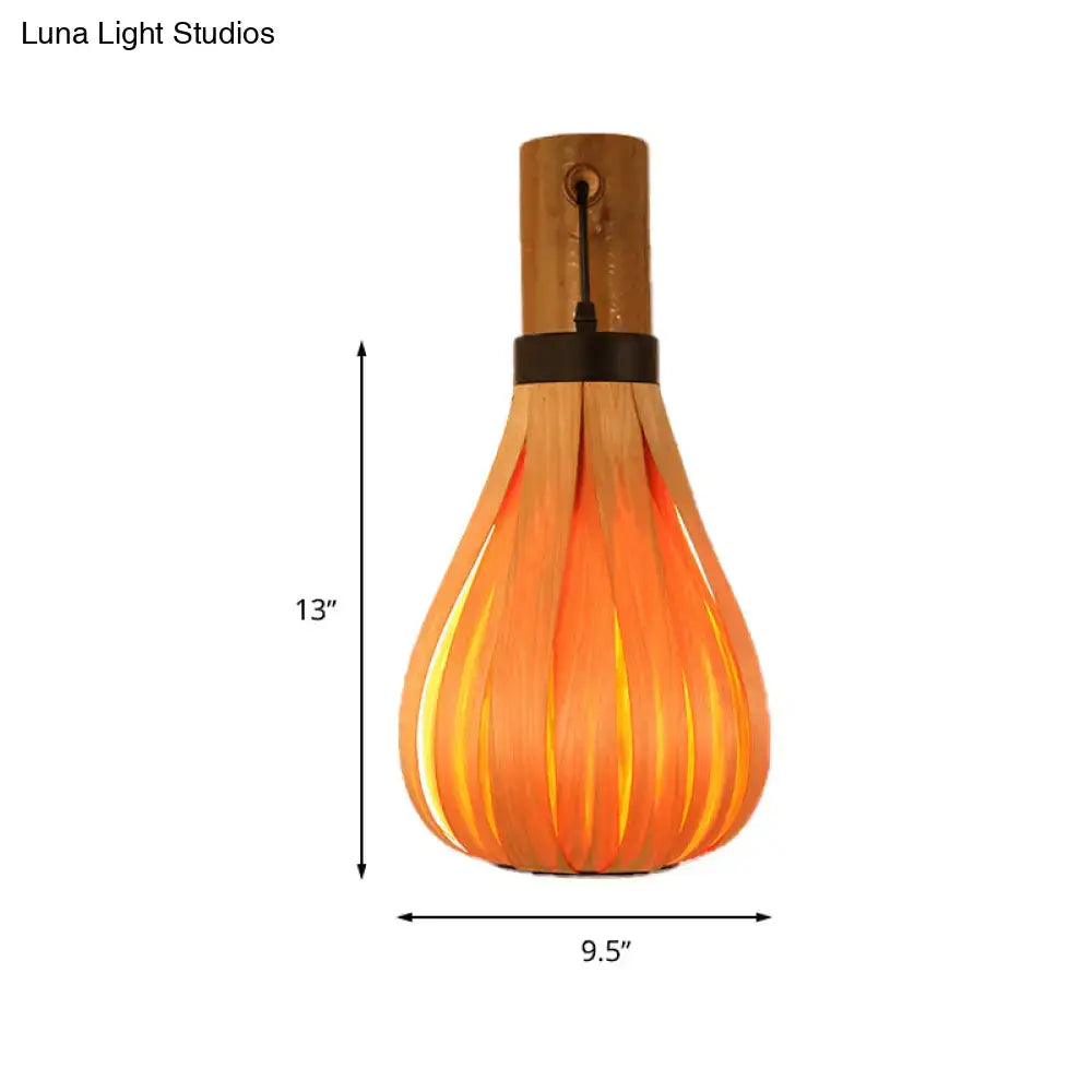 Modernist orange wood slat wall sconce with a warm orange bamboo frame and black accent band for foyer lighting