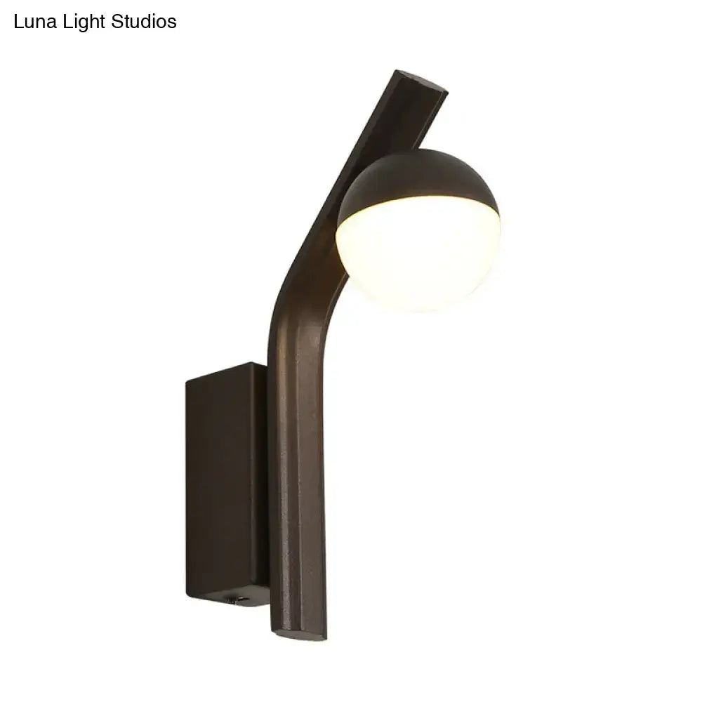 Modernist orb sconce black wall lamp with sleek curved arm and frosted glass shade for stairway lighting