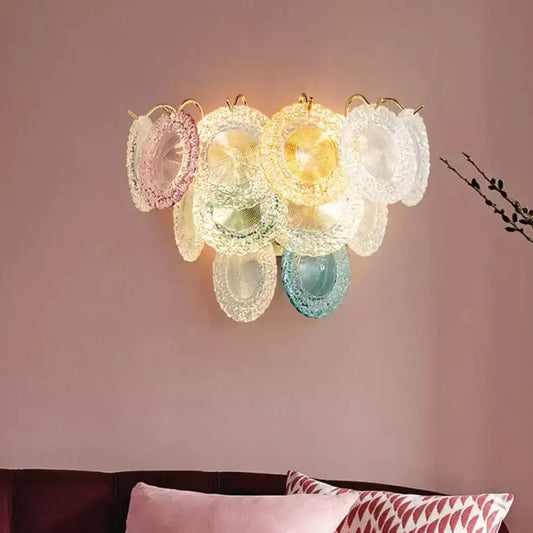 Pastel-colored translucent glass layered disc wall light with gold-toned metal frame for dining room use