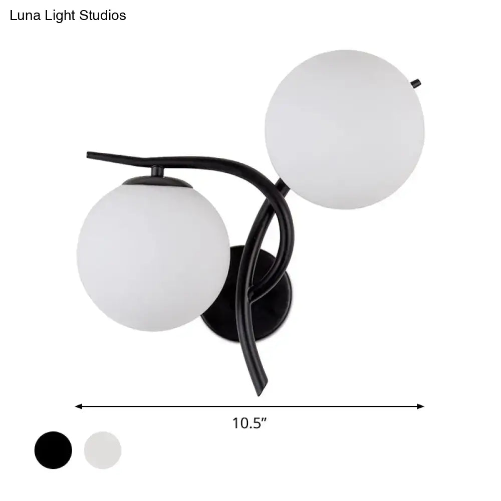 Modernist black metal light fixture with silver accents and milky glass globe shades for bedroom use
