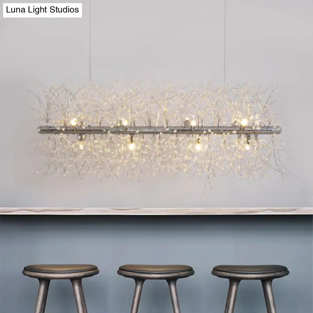 Decorbites modernist metallic branch island pendant light in silver with crystal bead deco strands emitting warm light