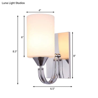 DecorBites™ DecorBites™ Modernist Silver Cylindrical Sconce Light: Wall-Mounted Lamp with Curved Arm & White Glass Shade