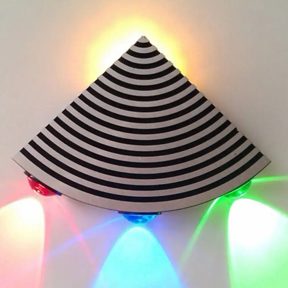 Modernist striped black and silver triangular wall lamp with concentric stripes and colorful red green blue yellow led lights