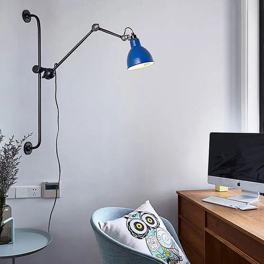Blue industrial-style wall light with articulated black metal arms in modernist style for dining room use