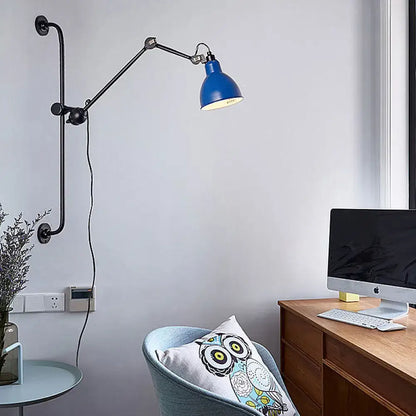 Blue industrial-style wall light with articulated black metal arms in modernist style for dining room use