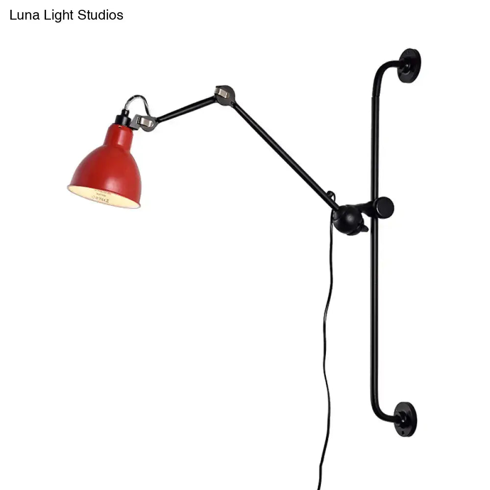 Red enamel lampshade on a black articulated wall light with adjustable arms in modernist style black white design