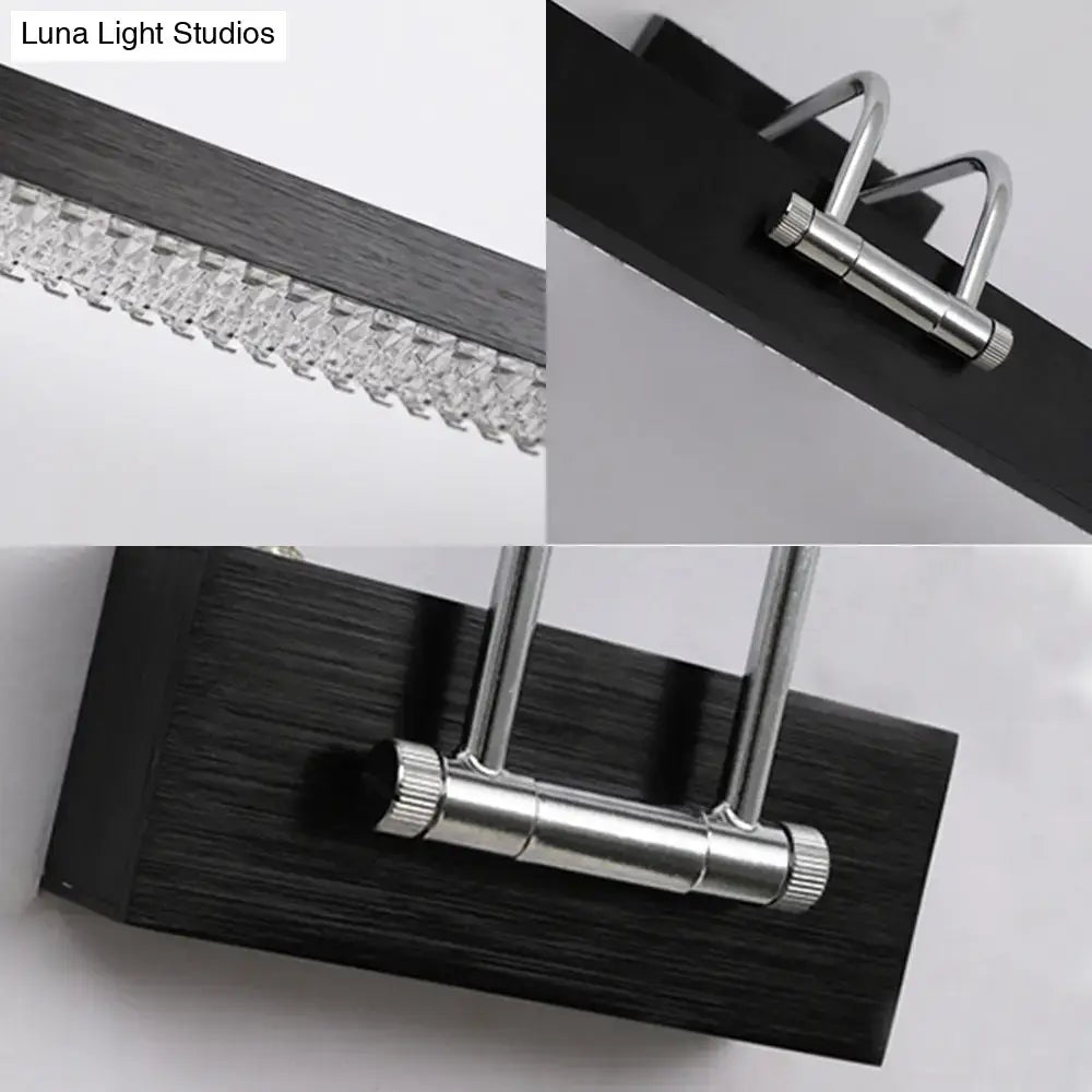 Modernist wall light featuring a black wood surface, silver metallic frame, and crystal led detail for bedroom vanity