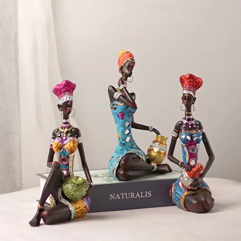 Three ornate dark-skinned black women resin art figures in vibrant traditional attire for living room decorbites black women decor