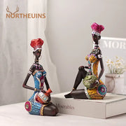 Two dark-skinned black women resin art figures with vibrant mosaic patterns for decorbites black women living room decor