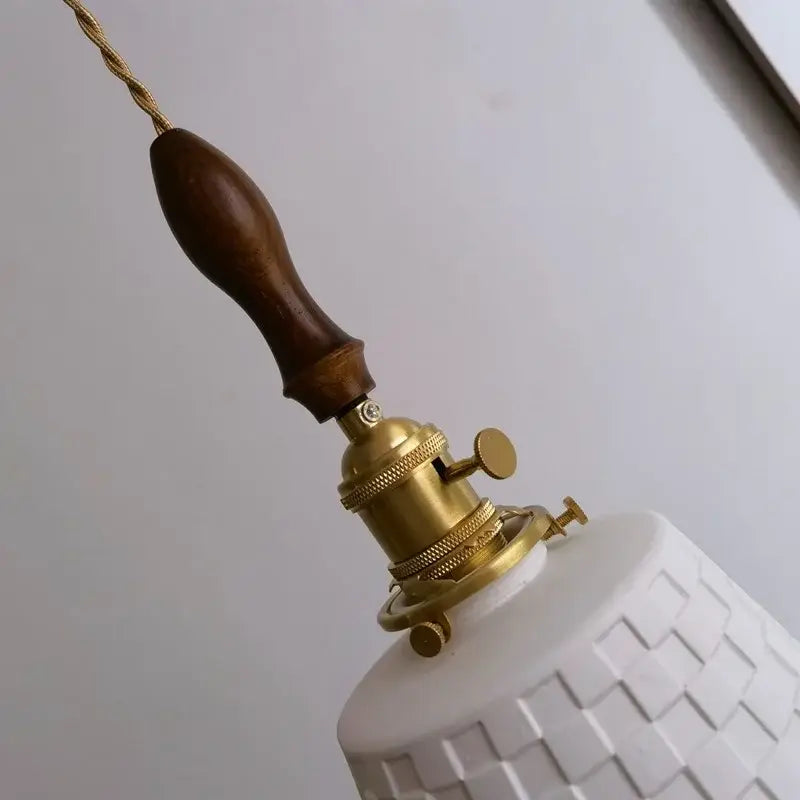 White ceramic pendant light with textured geometric pattern brass socket and dark wood handle for decorbites ceramic copper led