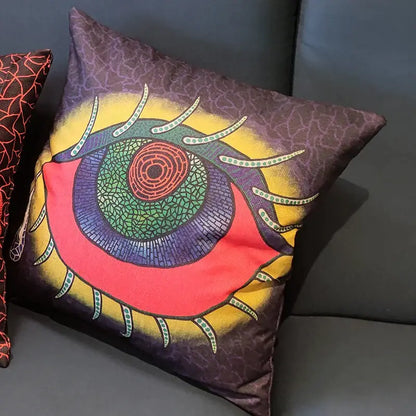 A vibrant decorbites cotton pumpkin pillowcase with a psychedelic eye design in red green and purple on brown background