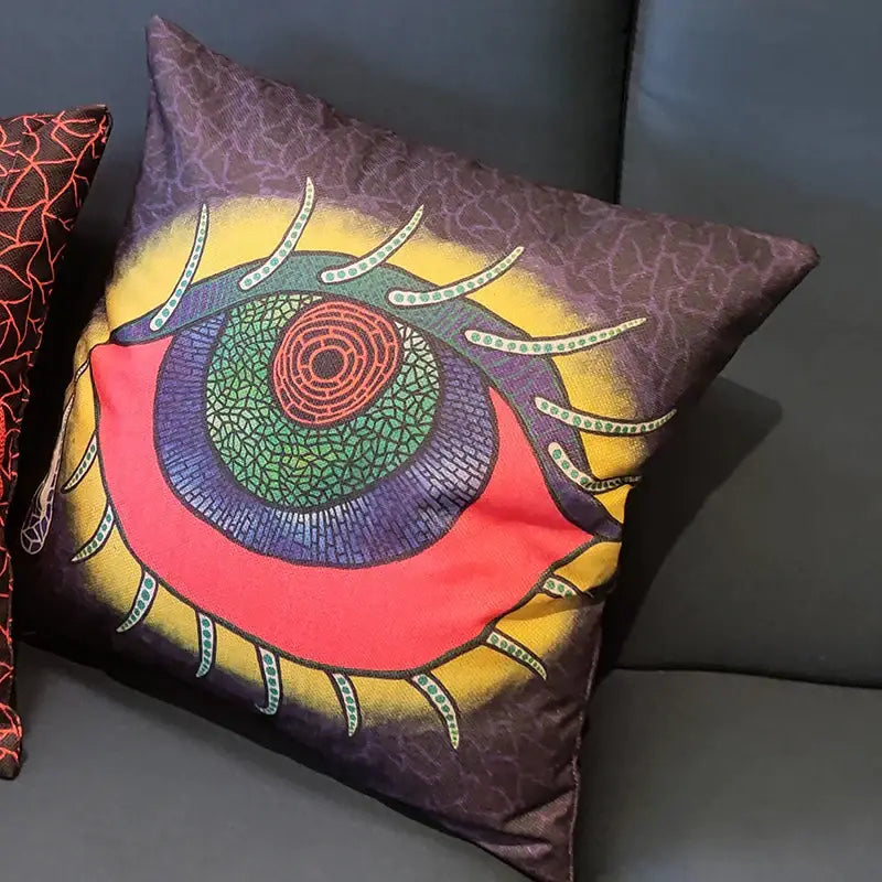 A vibrant decorbites cotton pumpkin pillowcase with a psychedelic eye design in red green and purple on brown background