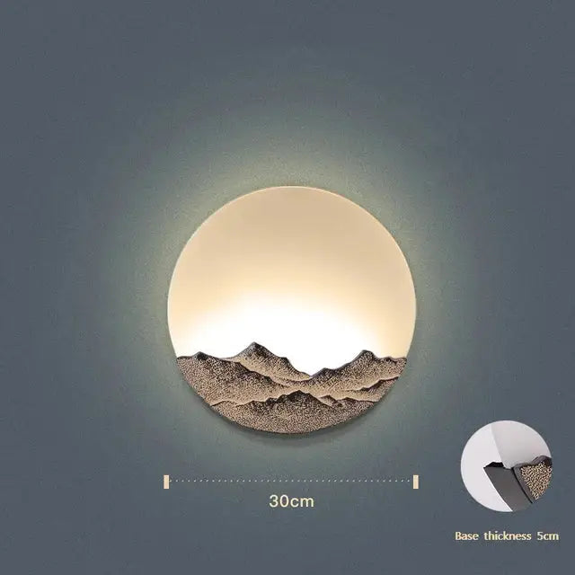 Circular wall light with warm glow featuring white diffuser and bronze mountain design decorbites led wall light for bedroom