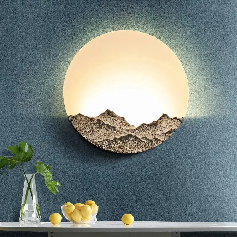 Mountain landscape led wall light by decorbites featuring a warm glowing upper half and textured earthy tones design