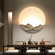 Circular decorbites led wall light with textured dark mountain design and warm glow for bedroom decor