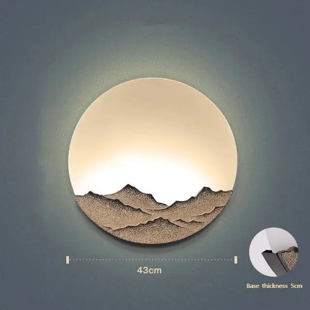 Circular mountain landscape led wall light with warm glow and textured brown silhouette for bedroom decorbites led wall decor
