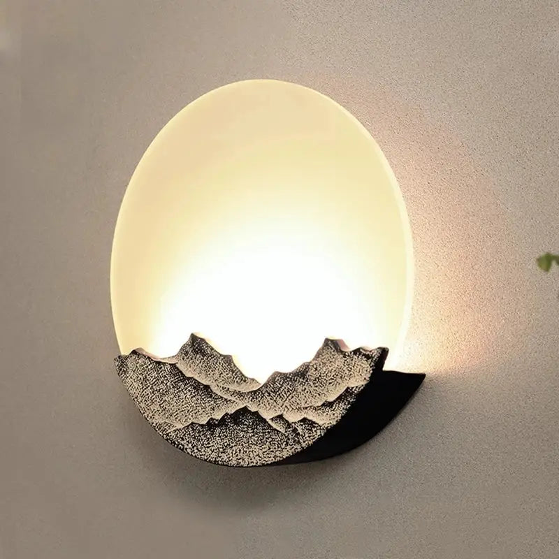 Warm-toned oval mountain landscape led wall light with textured dark gray silhouette for bedroom decorbites led wall decor