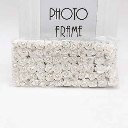 A package of delicate white 144pcs 2cm artificial paper roses neatly arranged for wedding decor by decorbites