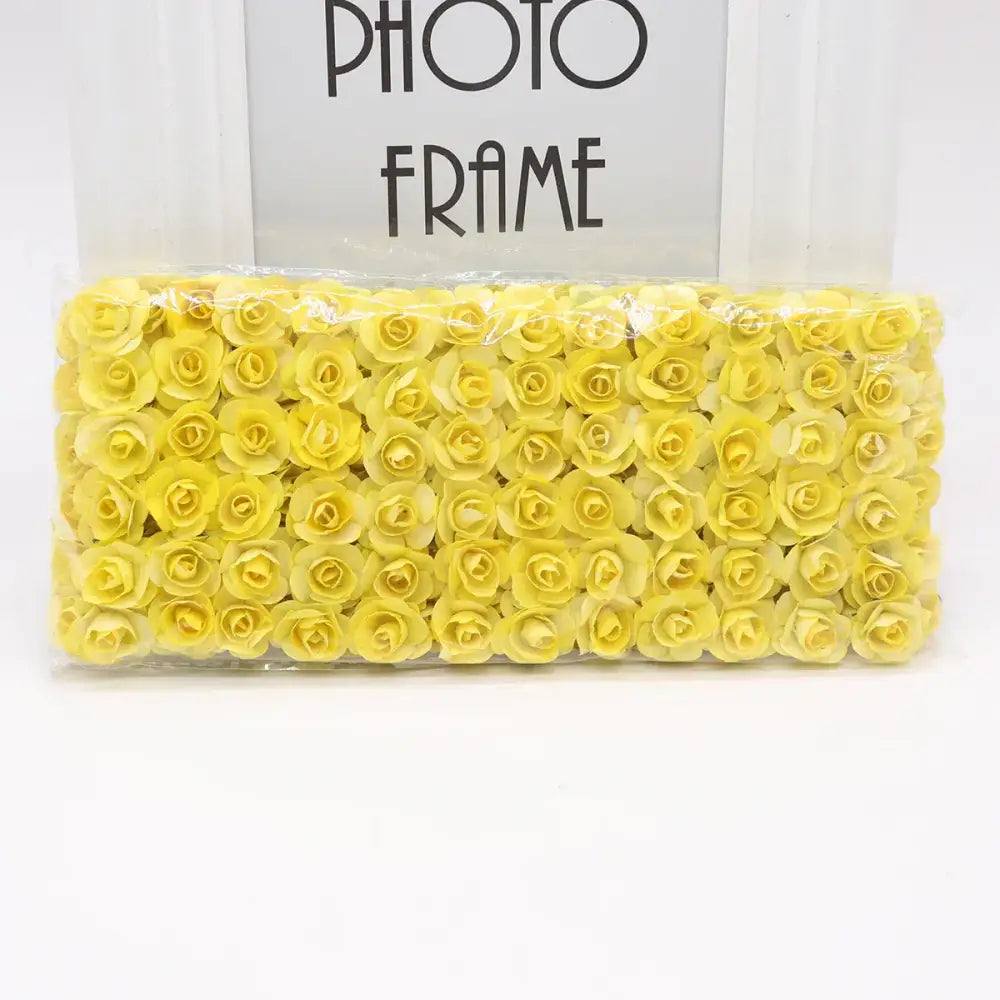 A package of decorbites 144pcs 2cm artificial yellow paper roses neatly arranged for wedding decor or bedroom use