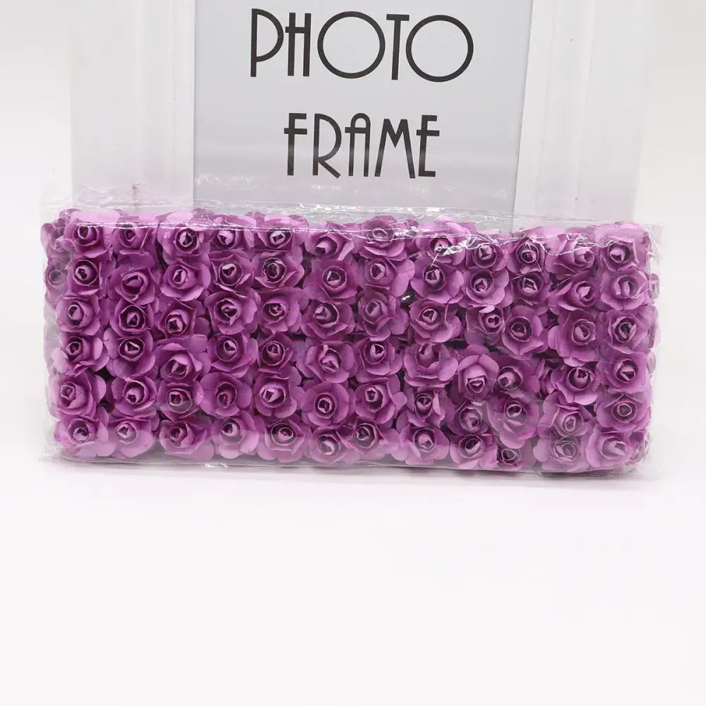 A package of purple decorbites 144pcs 2cm artificial paper roses neatly arranged and sealed in clear plastic for decor